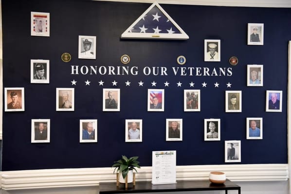 Wall honoring veterans with framed photographs
