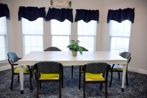 Bright dining area with a large table and chairs