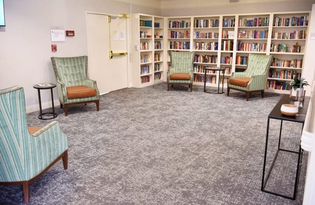 Cozy reading area with comfortable chairs and shelves of books