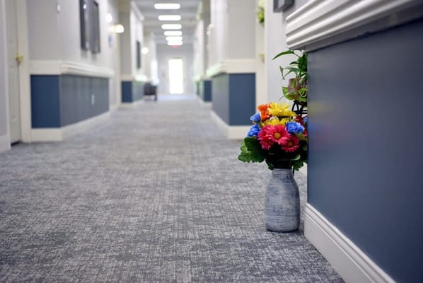 Brightly colored flowers in a hallway vase
