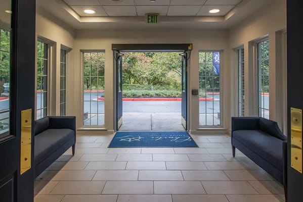 Bright entrance lobby with seating and access to outdoor space