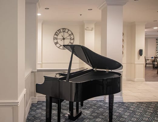 Grand piano in a well-lit lobby area