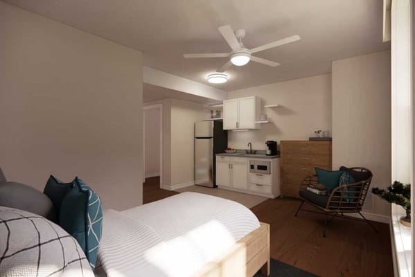 Cozy resident room featuring a kitchenette and living area.