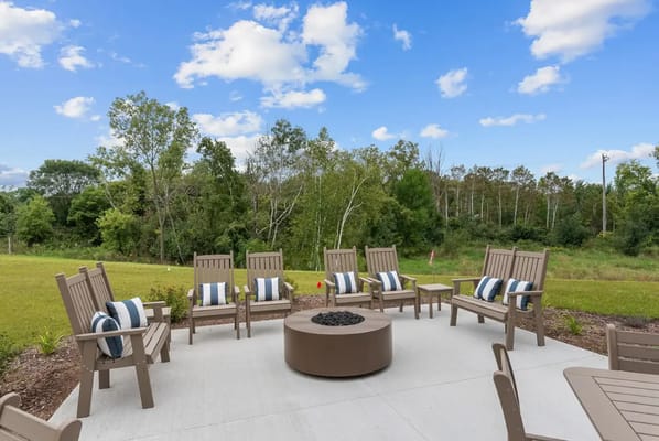 Outdoor seating area with a fire pit and nature view