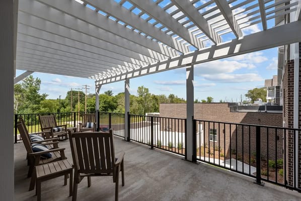 Outdoor patio area with seating and shaded pergola