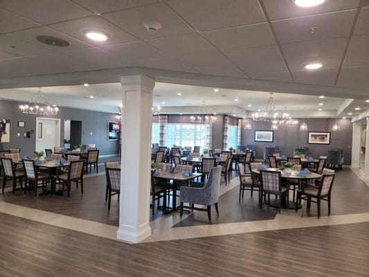 Bright dining area with tables and chairs set for meals