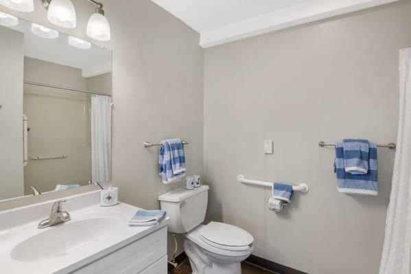 Clean and well-lit bathroom with blue towels