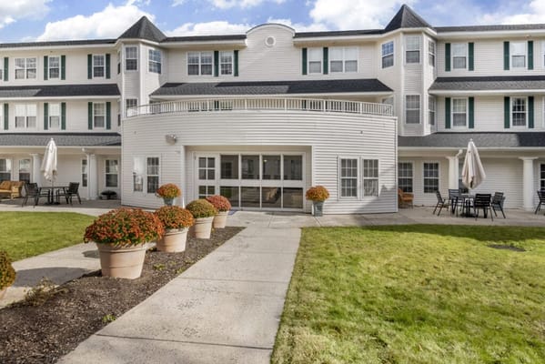Exterior view of Charter Senior Living with garden space