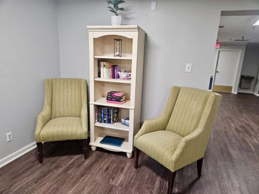 Cozy seating area with bookshelves in the common space