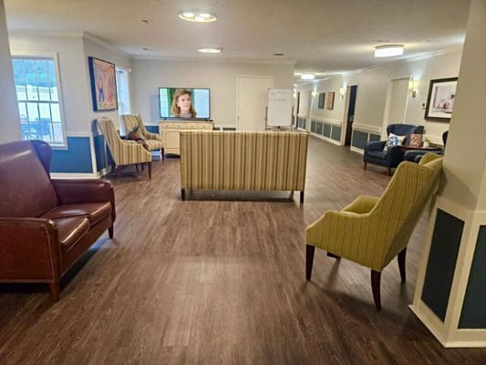 Interior common area with seating and a TV