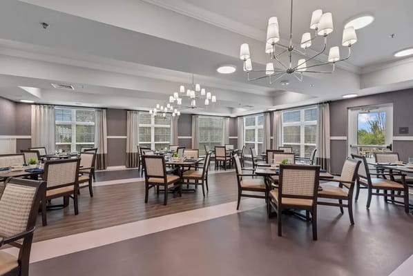 Bright dining room with tables and chairs set for meals