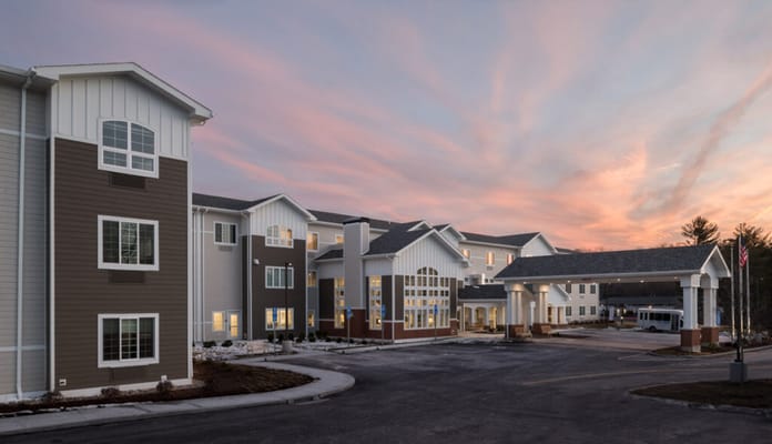 Exterior view of a senior living facility during sunset