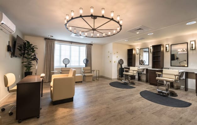 Well-lit beauty salon with styling stations and chairs