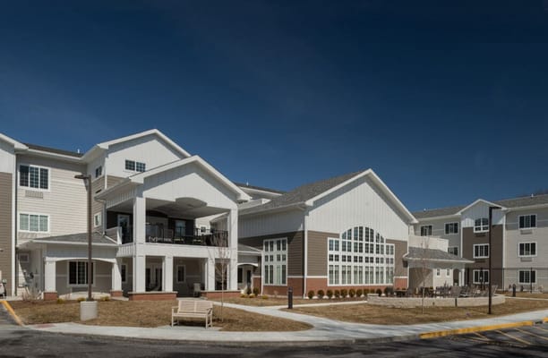 Exterior view of a senior living facility with landscaped areas