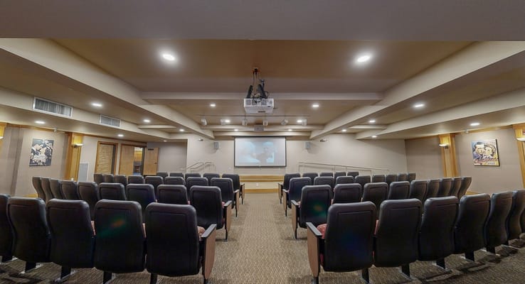 Interior view of a theater-style room with seating
