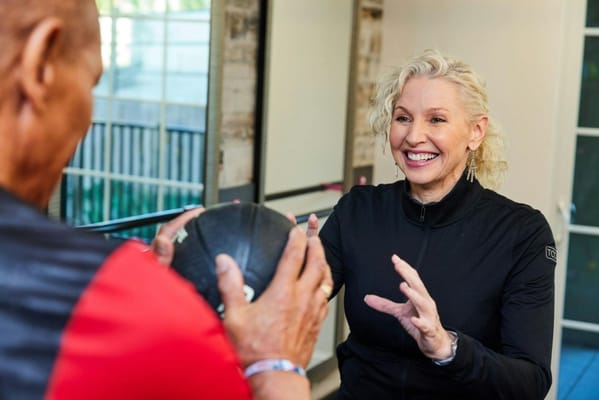 Two residents engaging in a fitness activity indoors