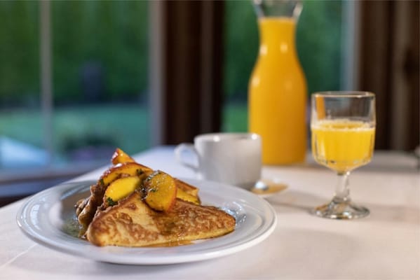 Delicious French toast with peaches and orange juice