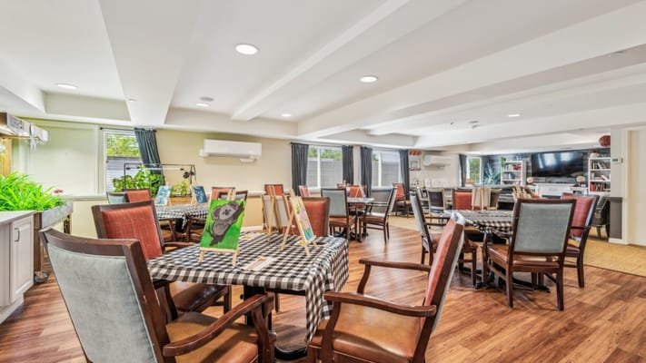 Bright, inviting common area with tables and art displays