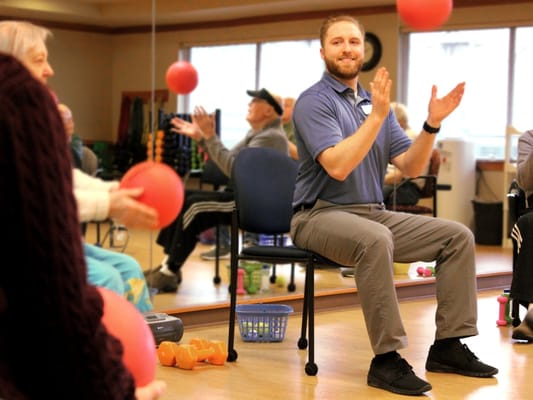 Residents participating in an activity in an exercise class