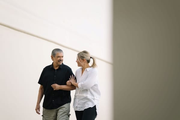 Two people walking together, smiling and engaged