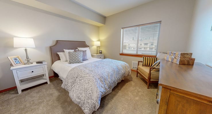 Cozy private resident room with a bed and furnishings