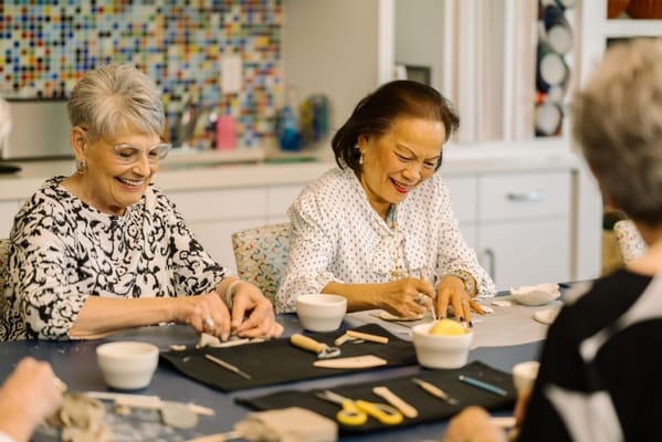 Residents engaged in a creative activity at a craft table