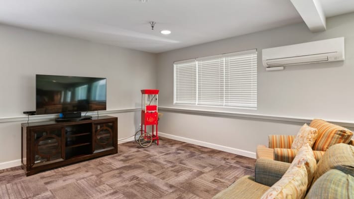 Bright common area with a TV and seating