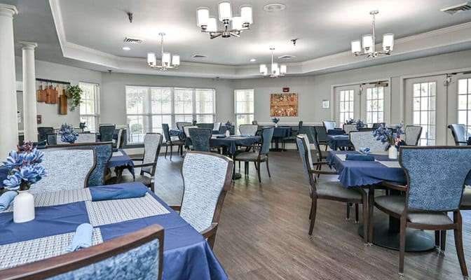 Dining area with blue table settings and floral centerpieces
