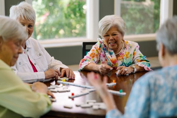 Seniors enjoying a game together at a table