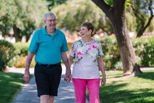 Couple walking hand in hand on a scenic path