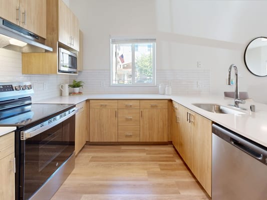 Modern kitchen interior with wooden cabinets and appliances