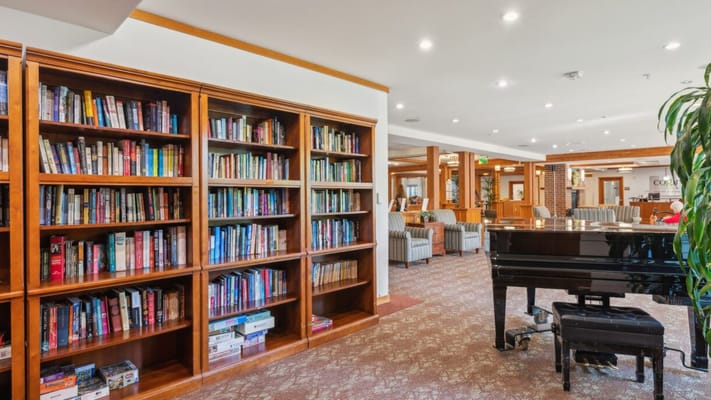 Interior view of a library and piano in a common area