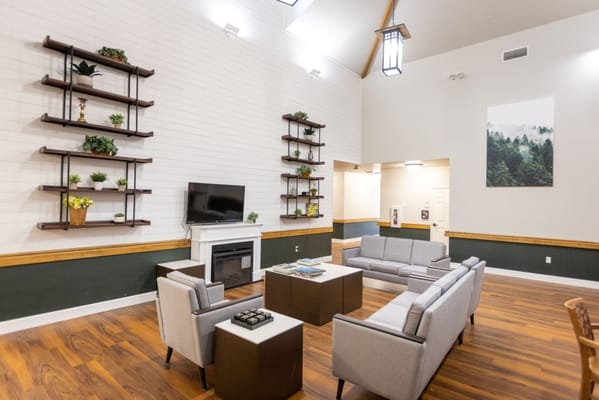 Bright common area with comfortable seating and decorative shelves