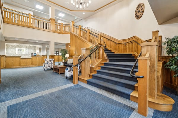 Bright interior of a senior living facility lobby with stairs