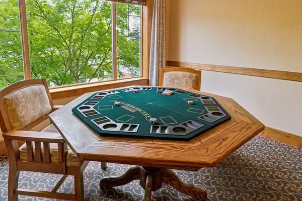 A game table in a cozy common area with a view of trees