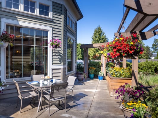 Outdoor seating area with flowers and tables
