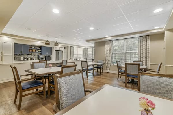 Bright common area with dining tables and kitchenette