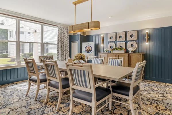 Bright dining room with eight chairs around a table