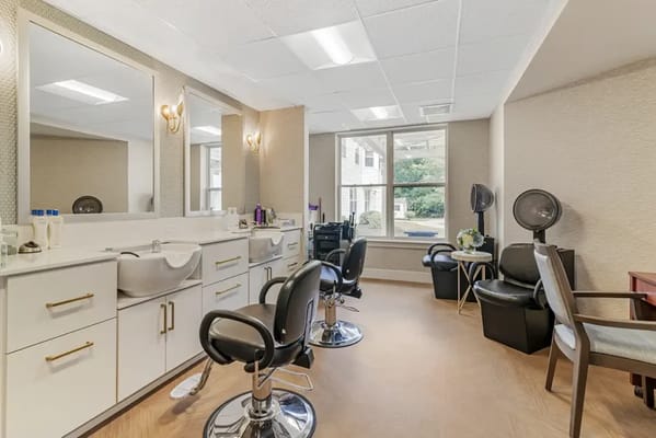 Well-lit salon area with styling chairs and mirrors