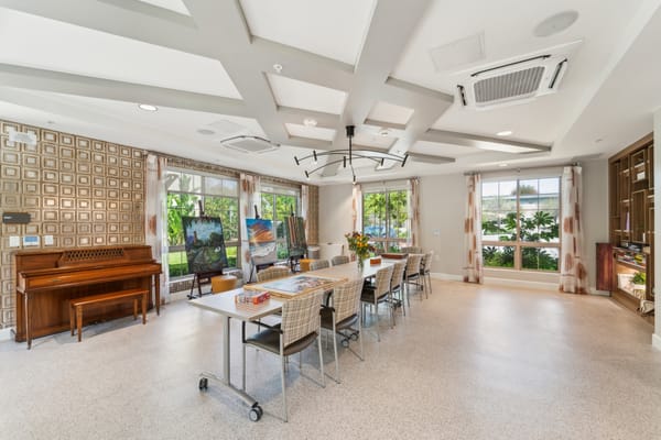 Common area with seating and piano in a bright facility
