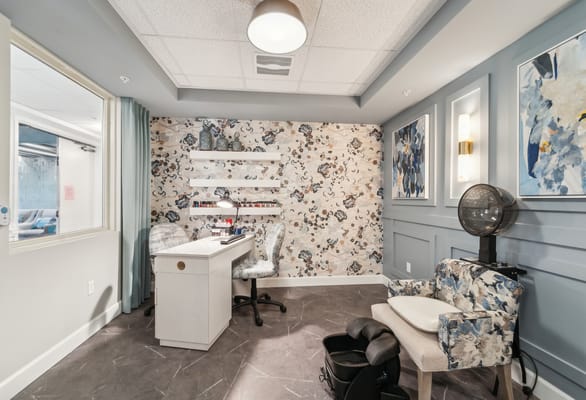 Stylish beauty treatment room with chairs and decor