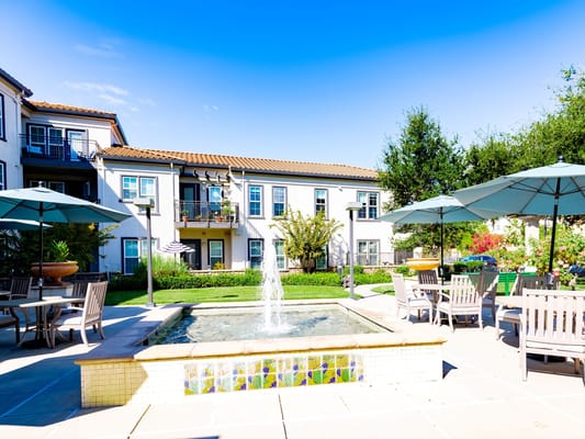 Outdoor courtyard with a fountain and seating area
