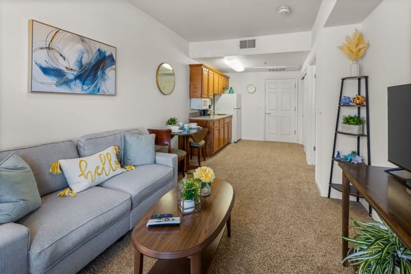 A cozy resident room with living area and kitchenette