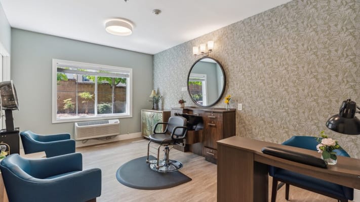 Interior view of a salon area with chairs and a mirror