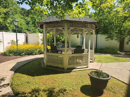 A gazebo in a beautifully landscaped garden