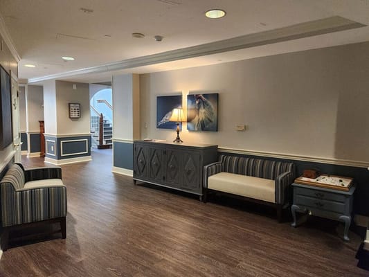 Common area with seating and artwork in a senior living facility