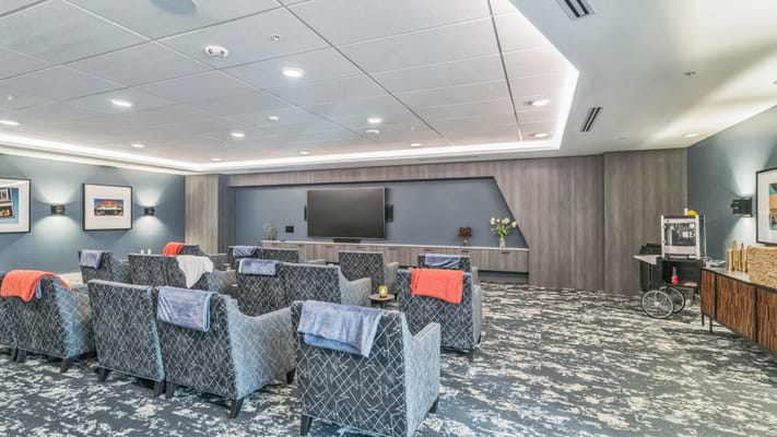 Bright common area with comfortable seating and TV