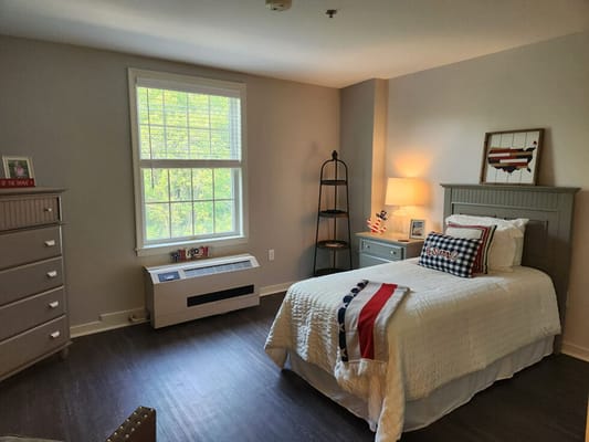 A well-furnished resident room with natural light