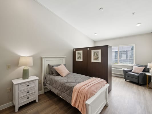 A cozy resident room with natural light