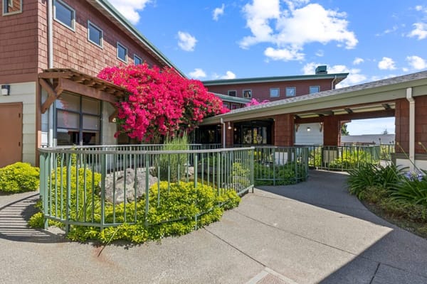 Exterior view of the facility with vibrant flowers